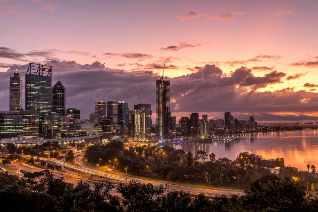 Perth city skyline at sunset with Swan River in the foreground, symbolising vibrant business opportunities in Western Australia