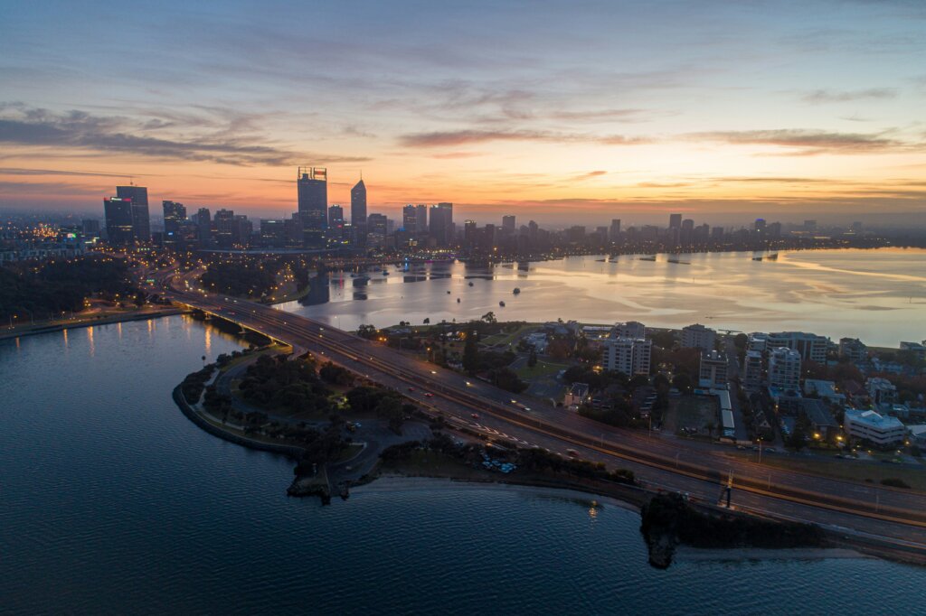 Perth city skyline with financial documents on a desk, representing local business valuation services.